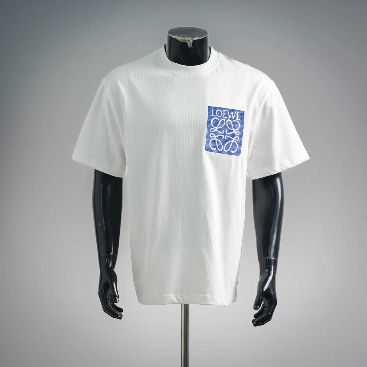 White crew-neck short-sleeve T-shirt with blue LOEWE logo patch on chest