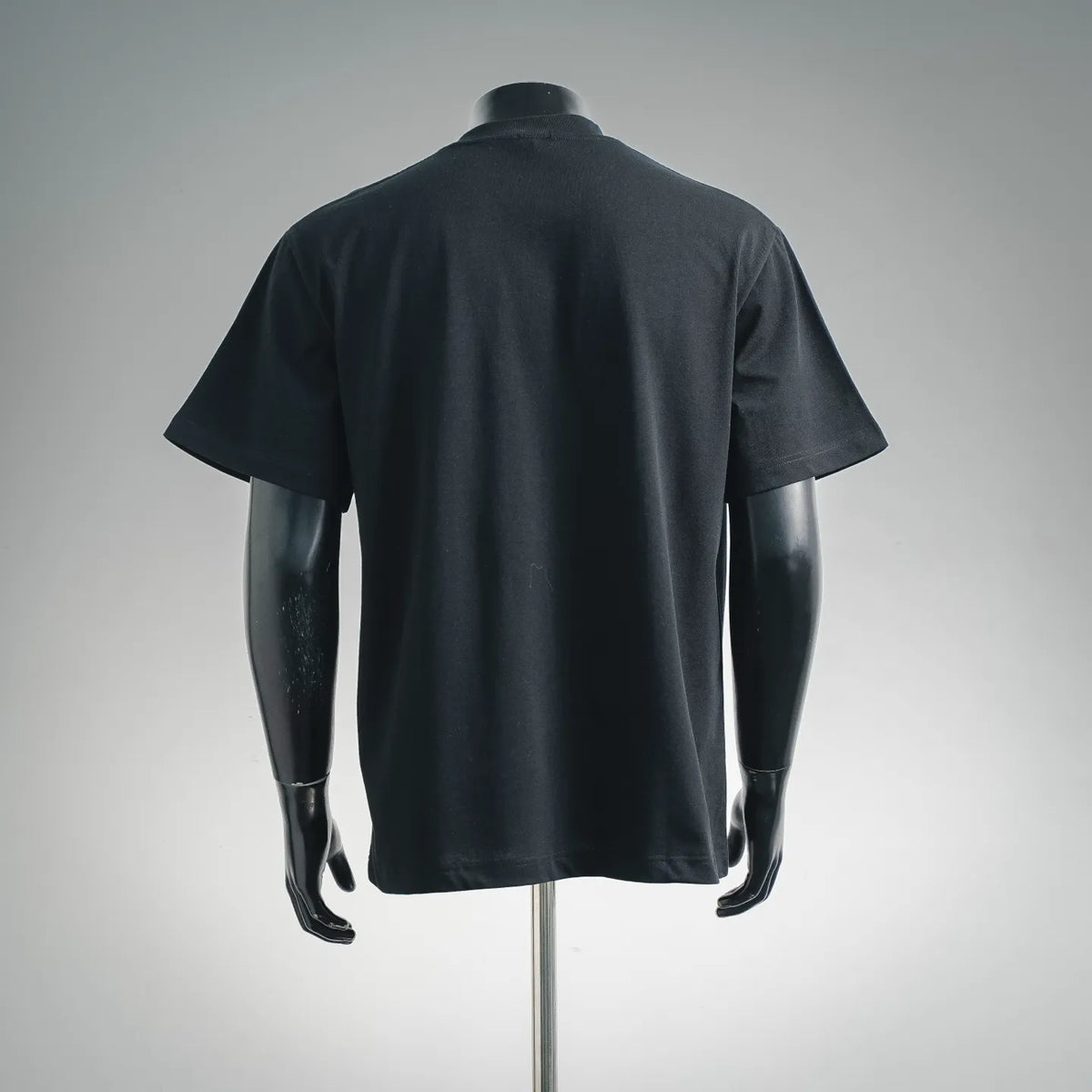 Black crewneck short-sleeve T-shirt, back view, smooth fabric and hemline