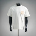 White short-sleeve T-shirt with small beige logo patch on left chest