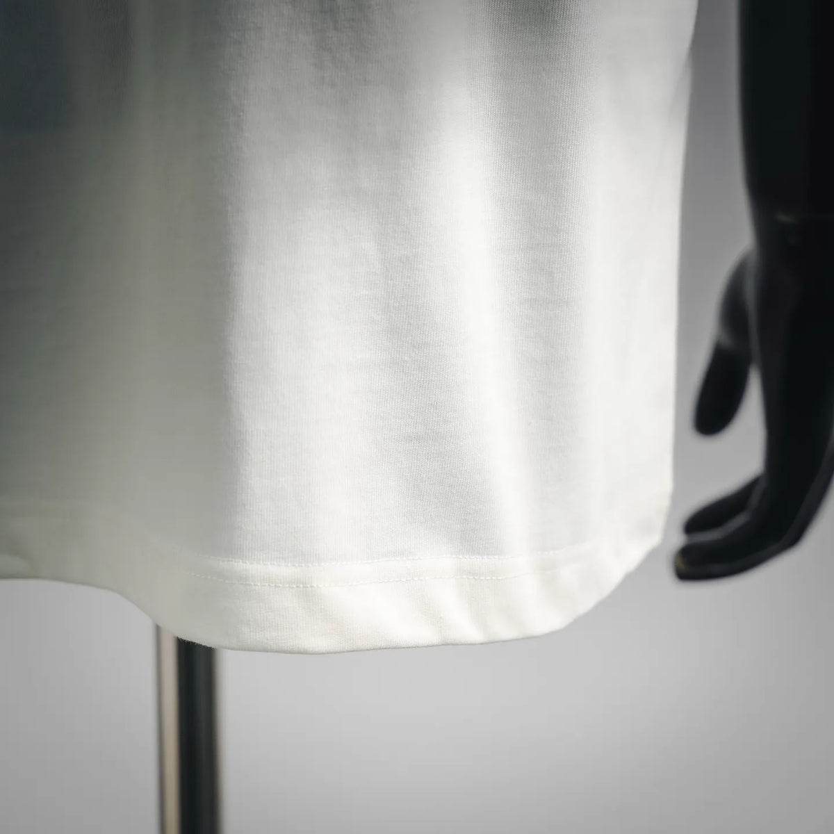 White T-shirt hem and side seam, no visible logo