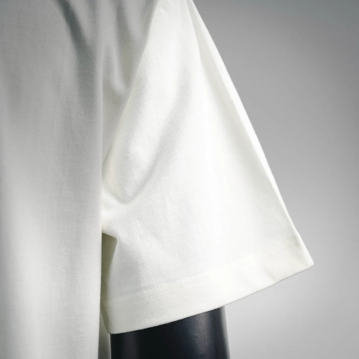 White short-sleeve T-shirt with curved hem and soft drape