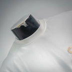 White T-shirt neckline and shoulder with partial beige logo on right side