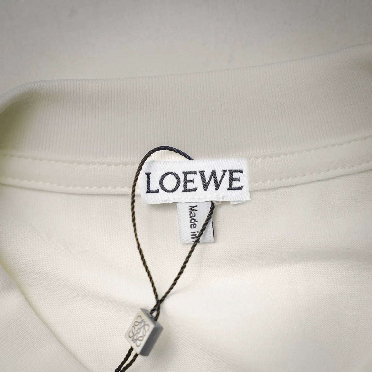 White T-shirt neck label with LOEWE branding and care tag