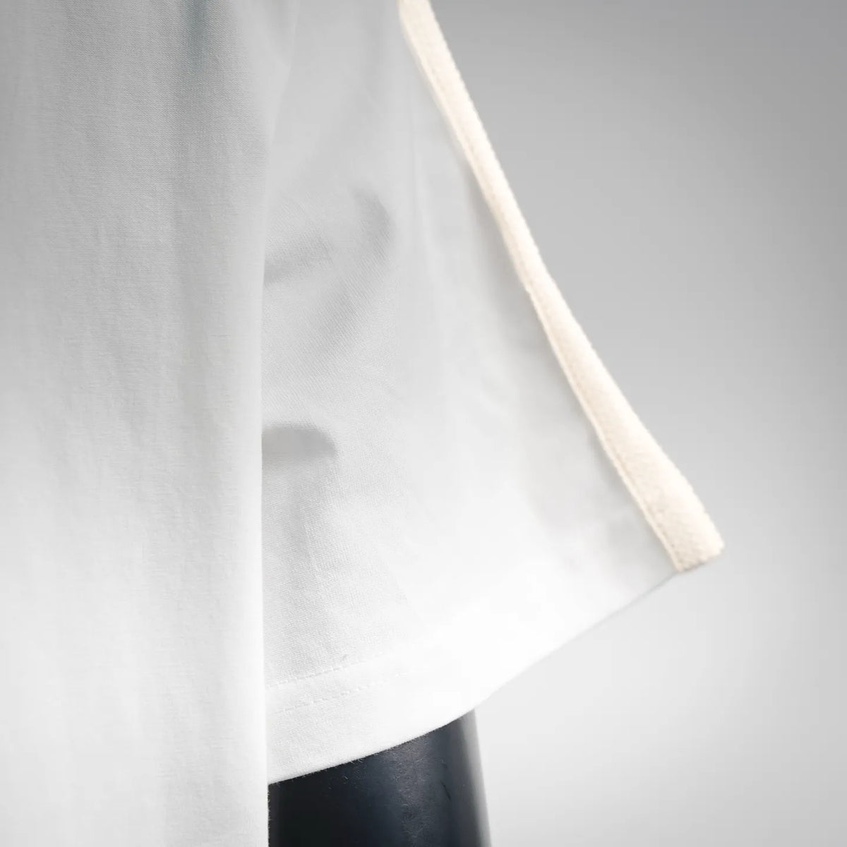 White T-shirt sleeve and hem with beige contrast trim