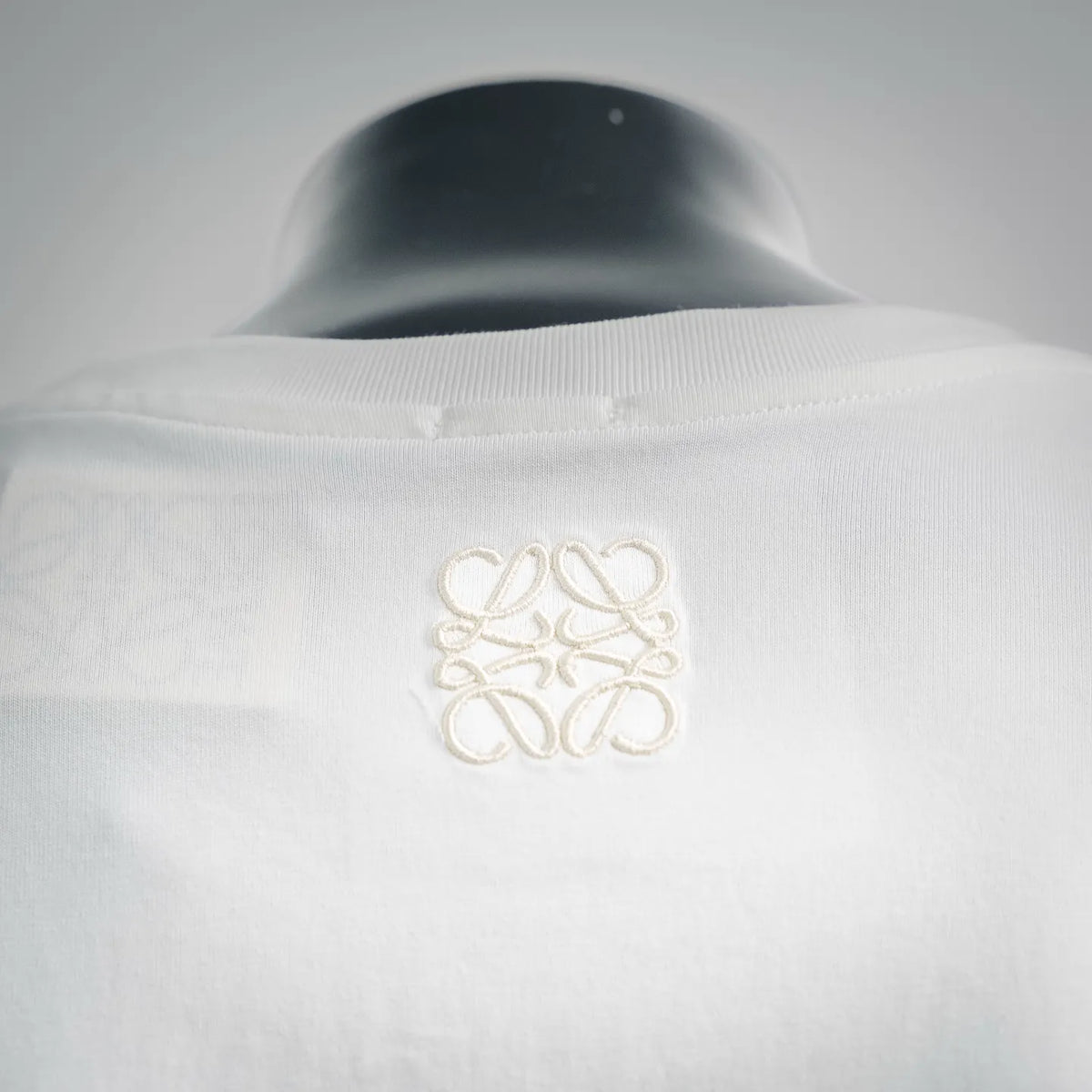White T-shirt neckline with small gold-toned back embroidery