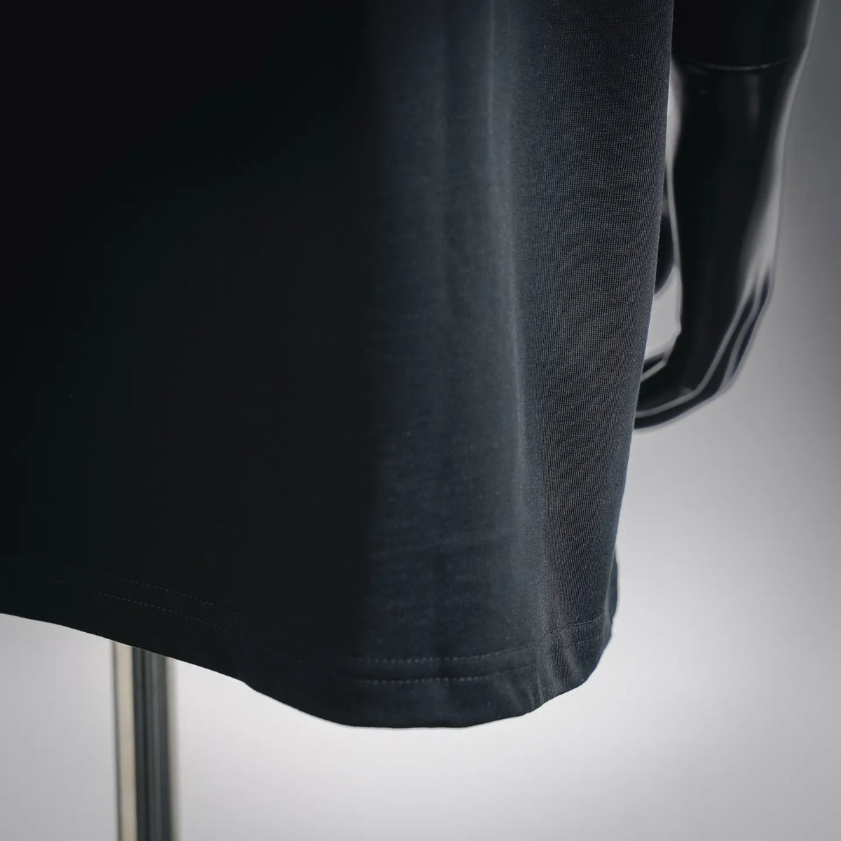 Black short-sleeve T-shirt hem close-up with stitched edge