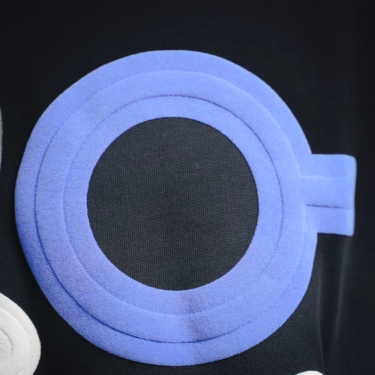 LOEWE shorts with a blue circular appliqué on black fabric