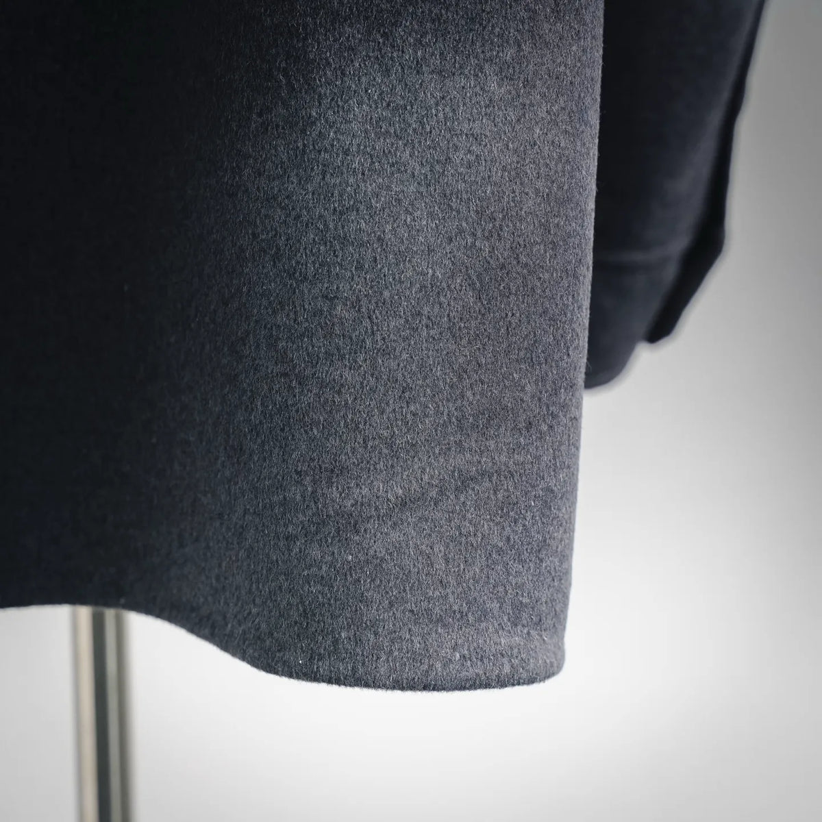 Dark gray wool coat hem close-up
