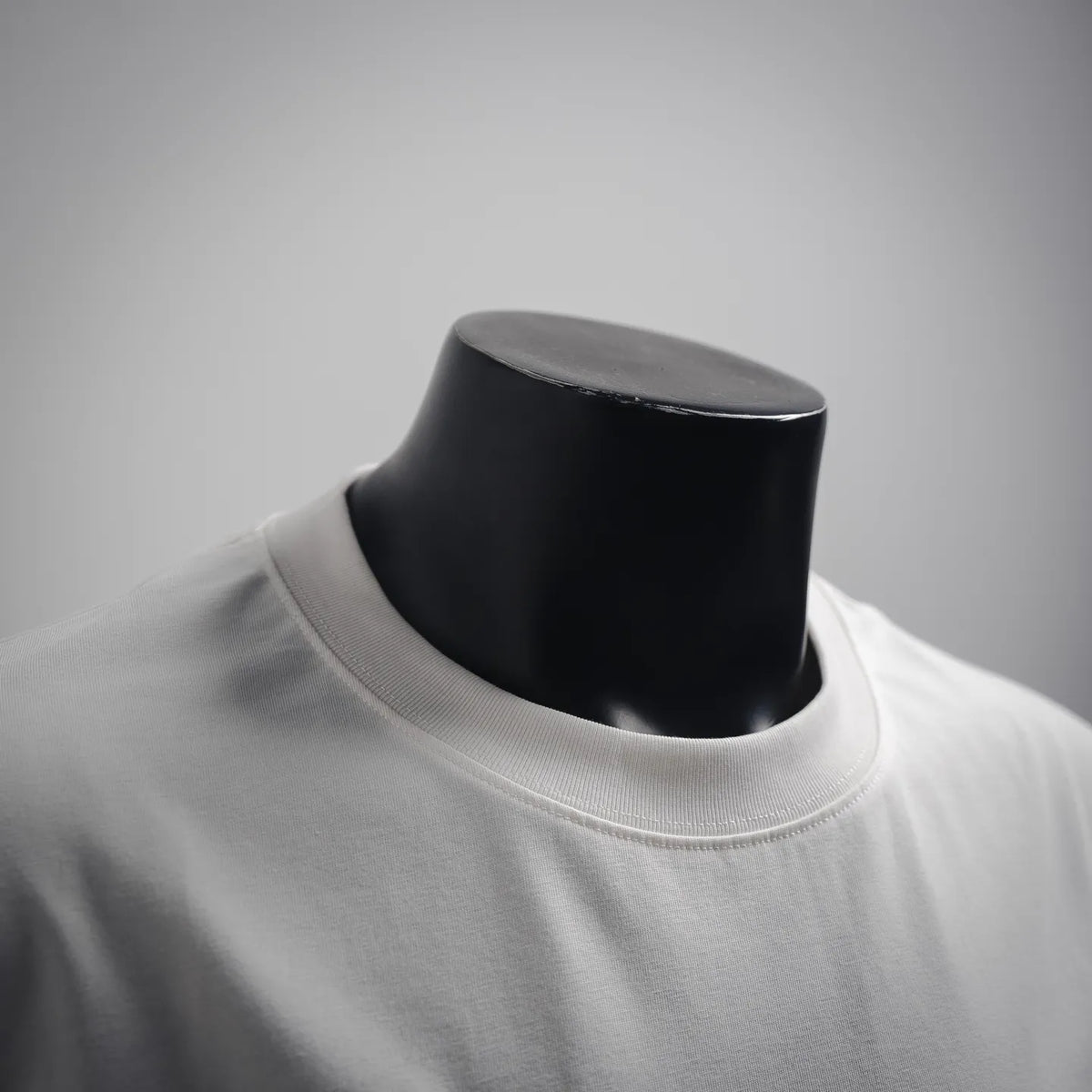 White crew-neck T-shirt with ribbed collar on mannequin