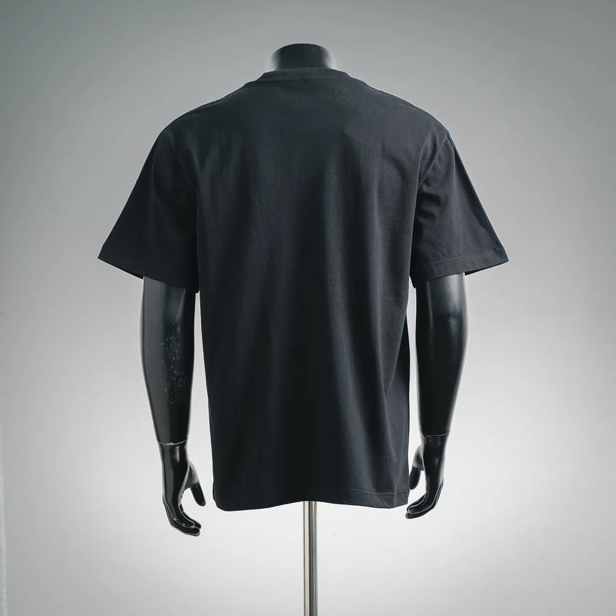 Back view of black short-sleeve T-shirt with mock crew collar