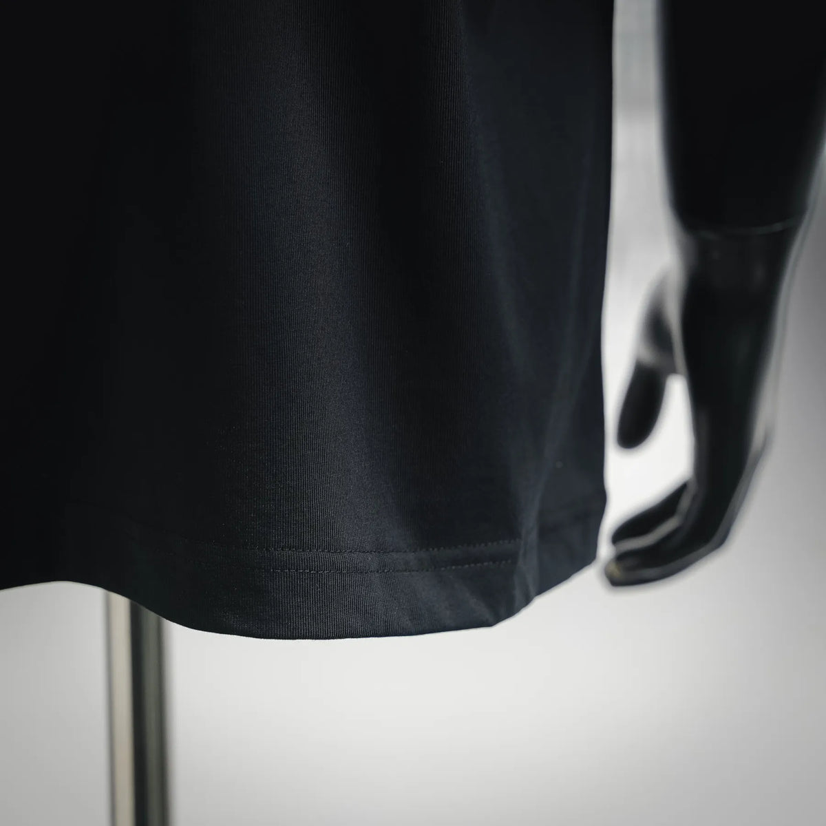 Black short-sleeve T-shirt hem and side seam