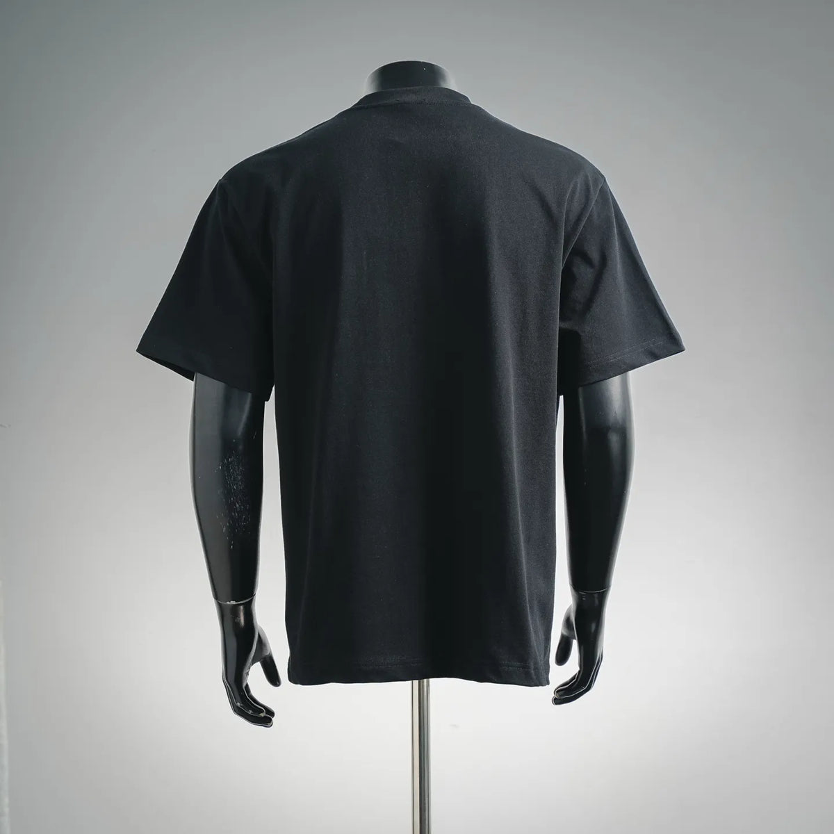 Black crewneck T-shirt on mannequin, back view with short sleeves