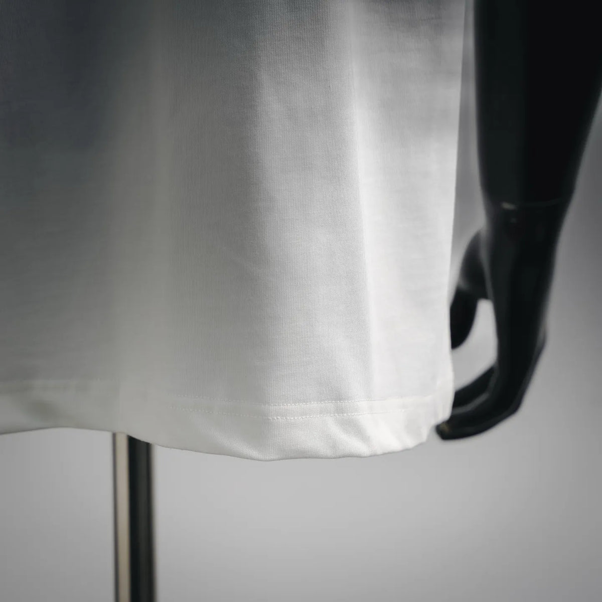 White T-shirt hem with double-stitched finish; short sleeves