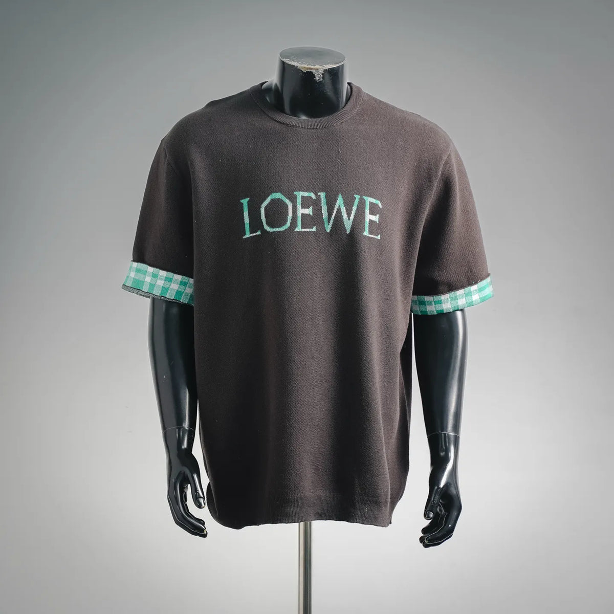 LOEWE short-sleeve shirt, dark gray/black with teal LOEWE logo and checkered cuffs