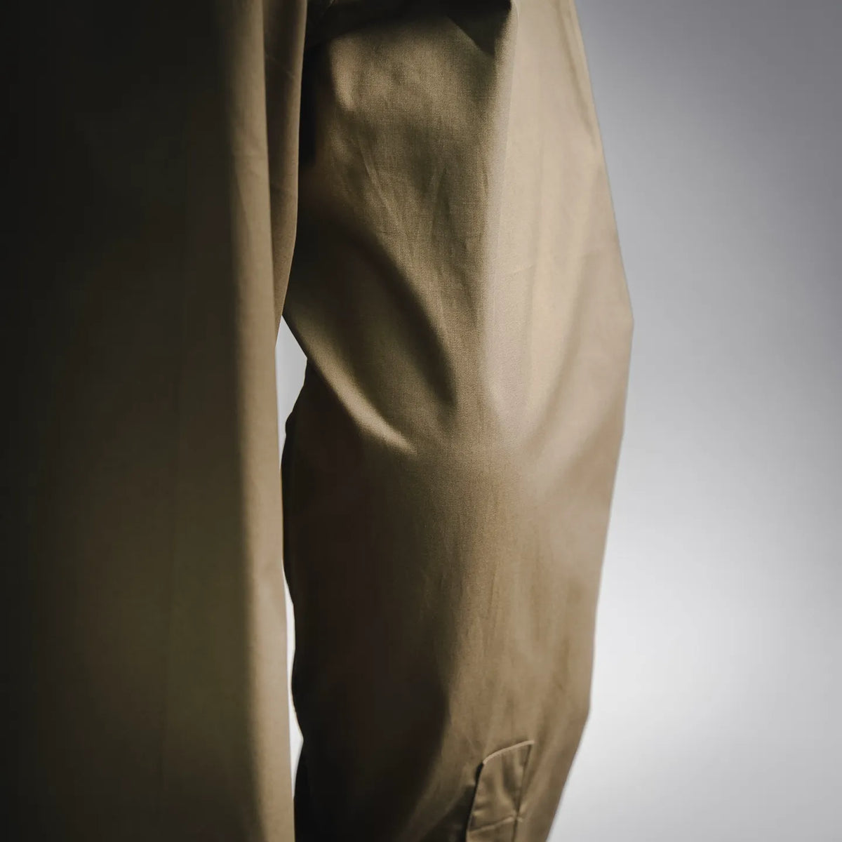 Men's long-sleeve button-up shirt fabric detail, olive/khaki close-up