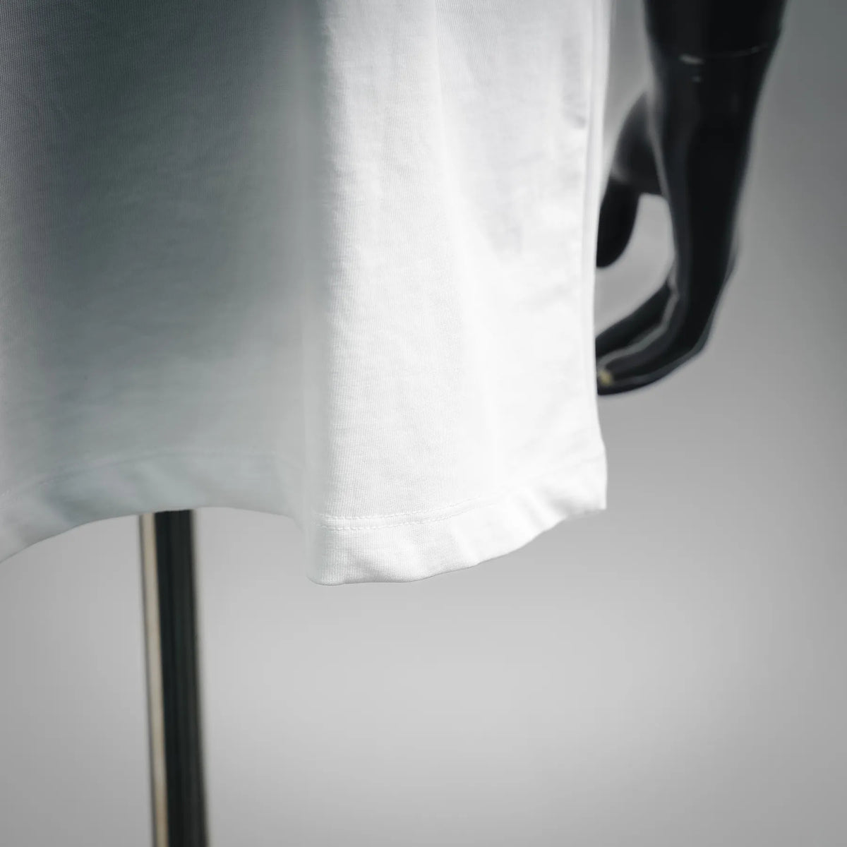 White T-shirt hem with stitched edge, close-up