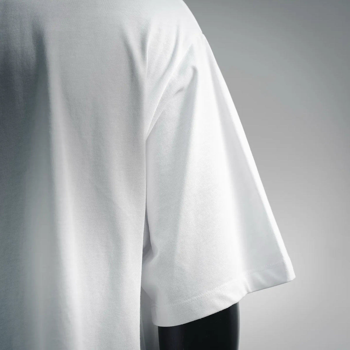 White short-sleeve T-shirt side seam and drape, close-up