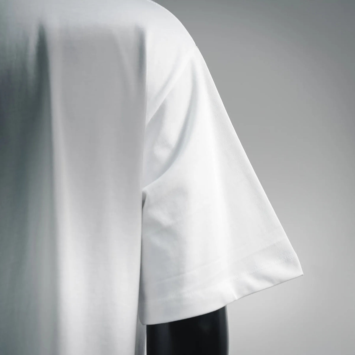 White T-shirt sleeve and shoulder drape with smooth crew neckline