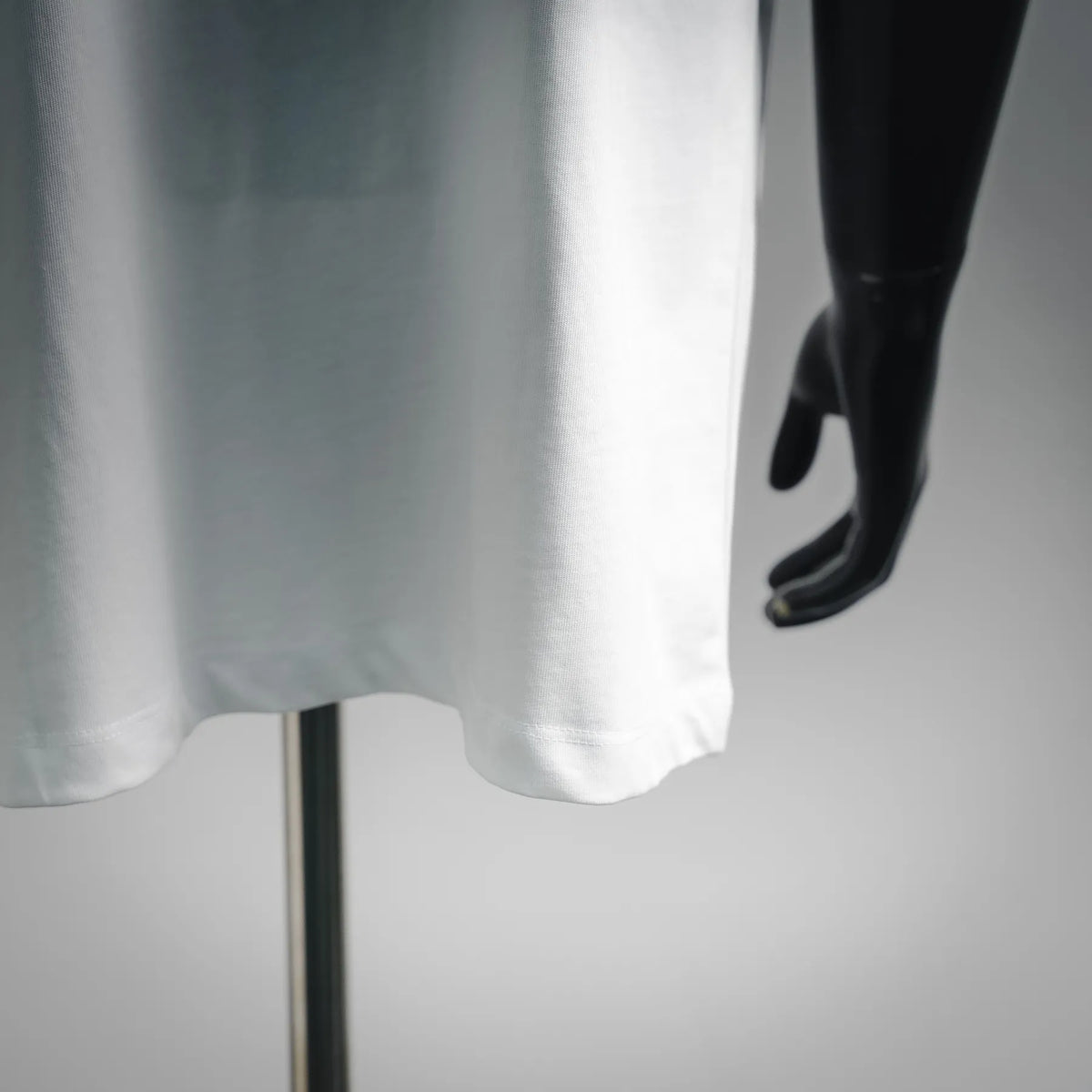 White T-shirt hem detail with short sleeve opening