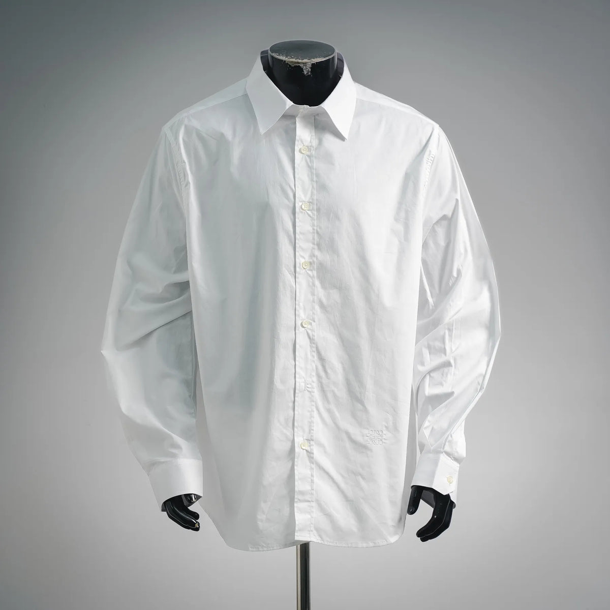 White button-up dress shirt with pointed collar and front button placket