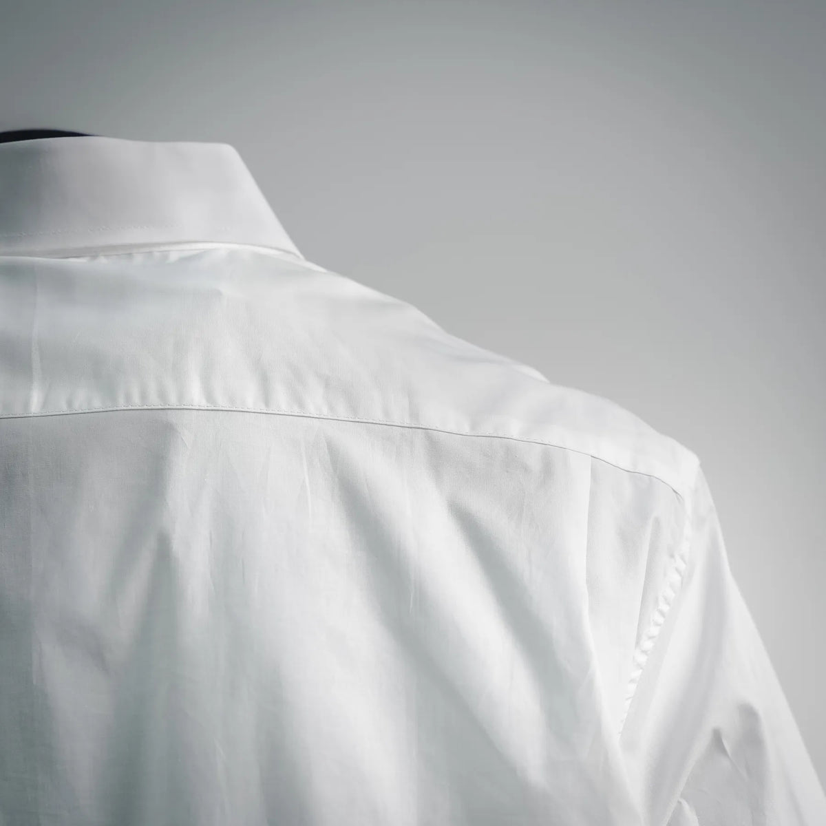 White dress shirt shoulder and upper back with pleated yoke detail