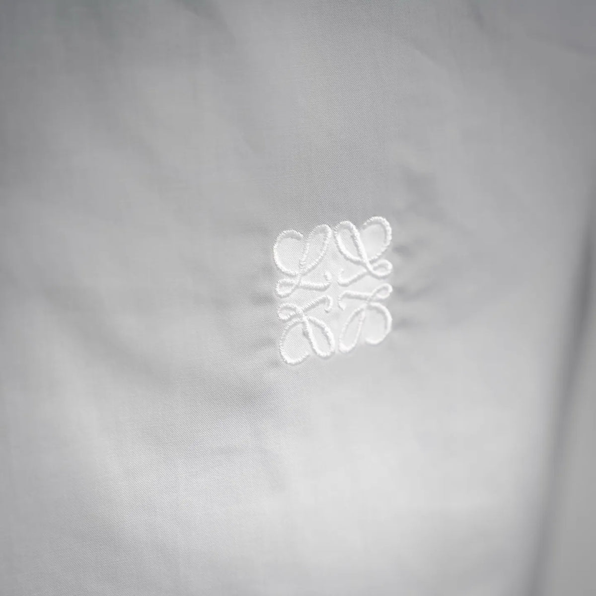 White dress shirt with small embroidered logo on chest