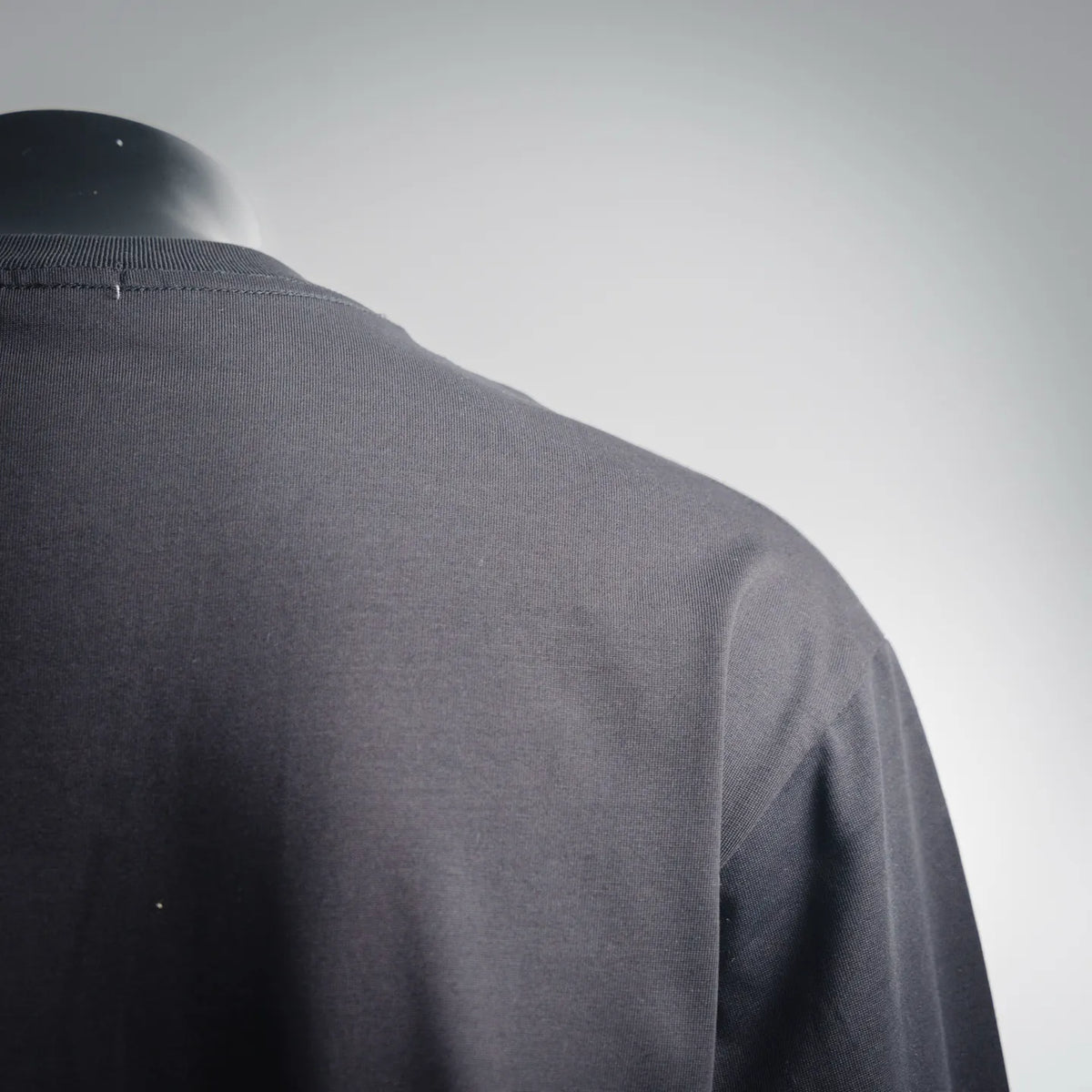 Back of dark LOEWE crewneck shirt with curved shoulder seam detail