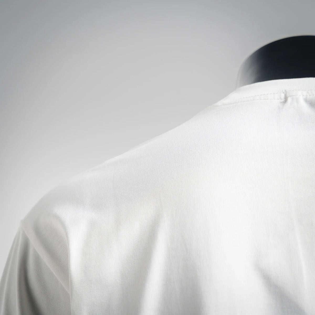 LOEWE white long-sleeve T-shirt, back neckline and shoulder seam close-up