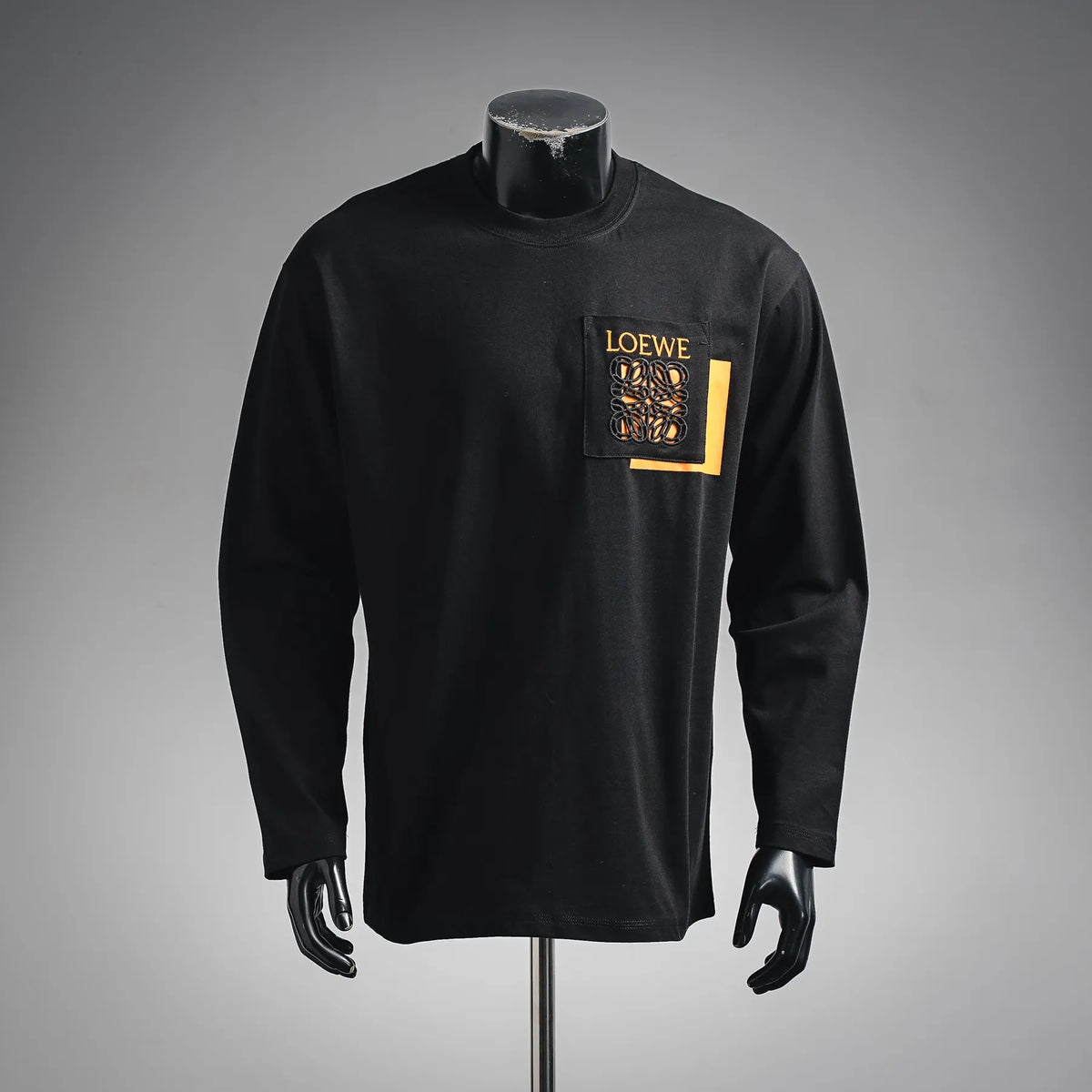 Black long-sleeve crewneck shirt with LOEWE logo patch at the chest