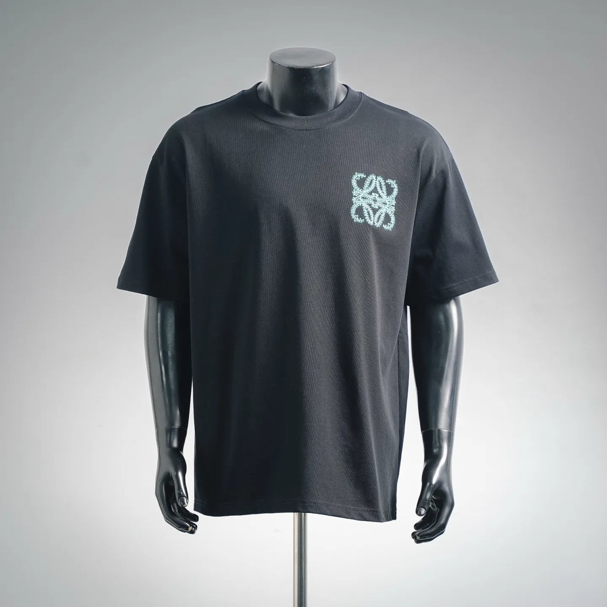Black short-sleeve T-shirt with turquoise embroidered logo on chest