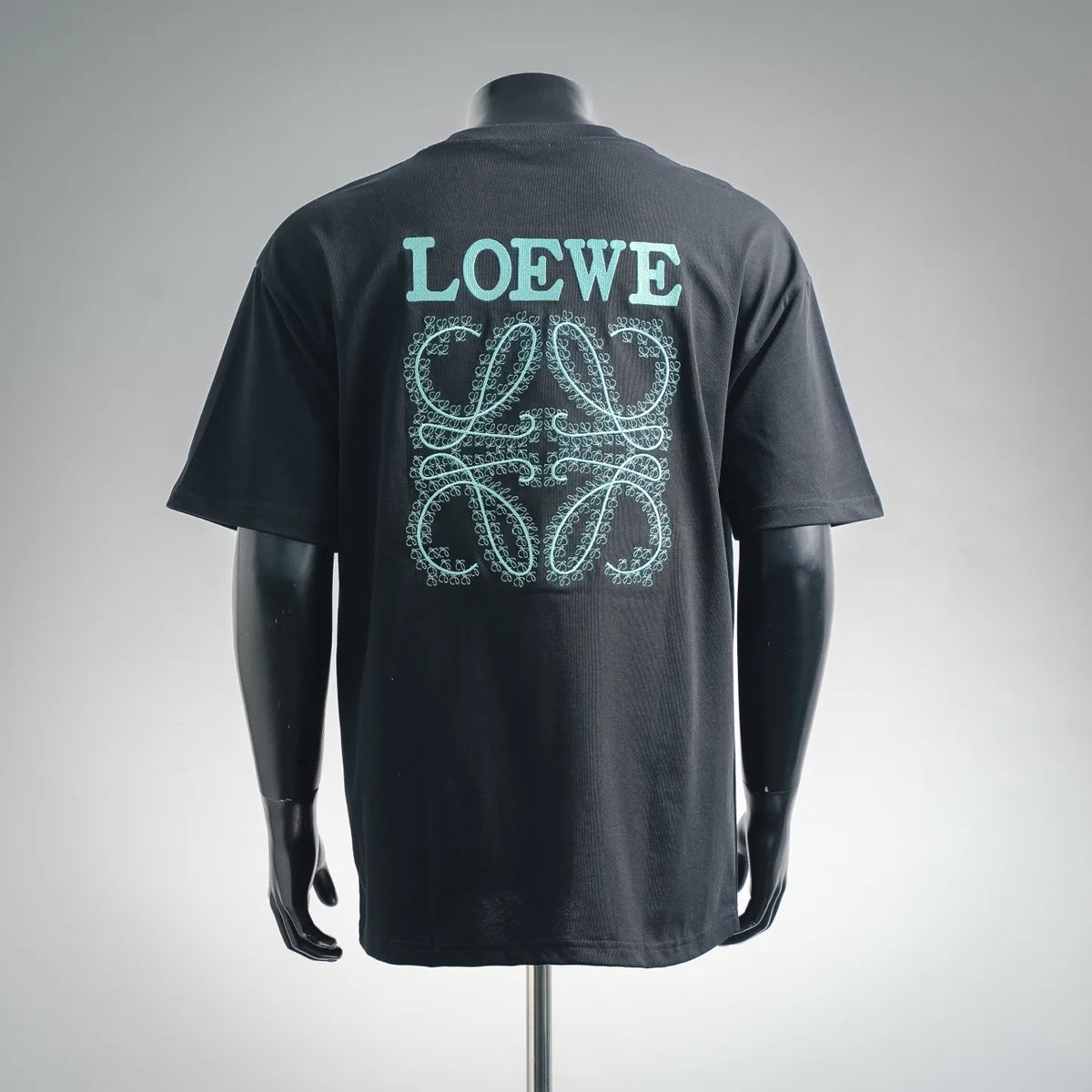 Black short-sleeve T-shirt, back view, turquoise LOEWE logo and embroidery