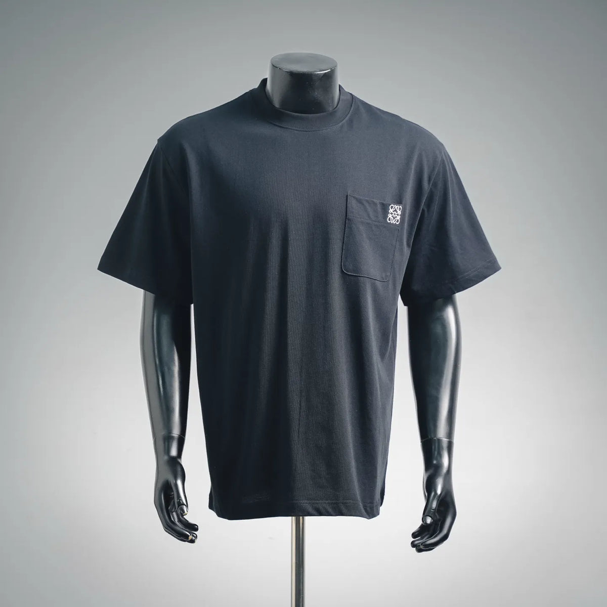 Dark navy short-sleeve t-shirt on mannequin with chest pocket and logo