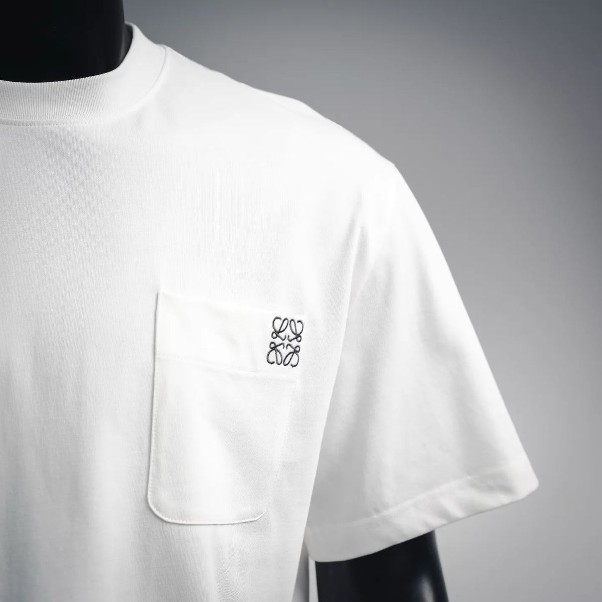 White T-shirt with chest pocket and embroidered logo on front