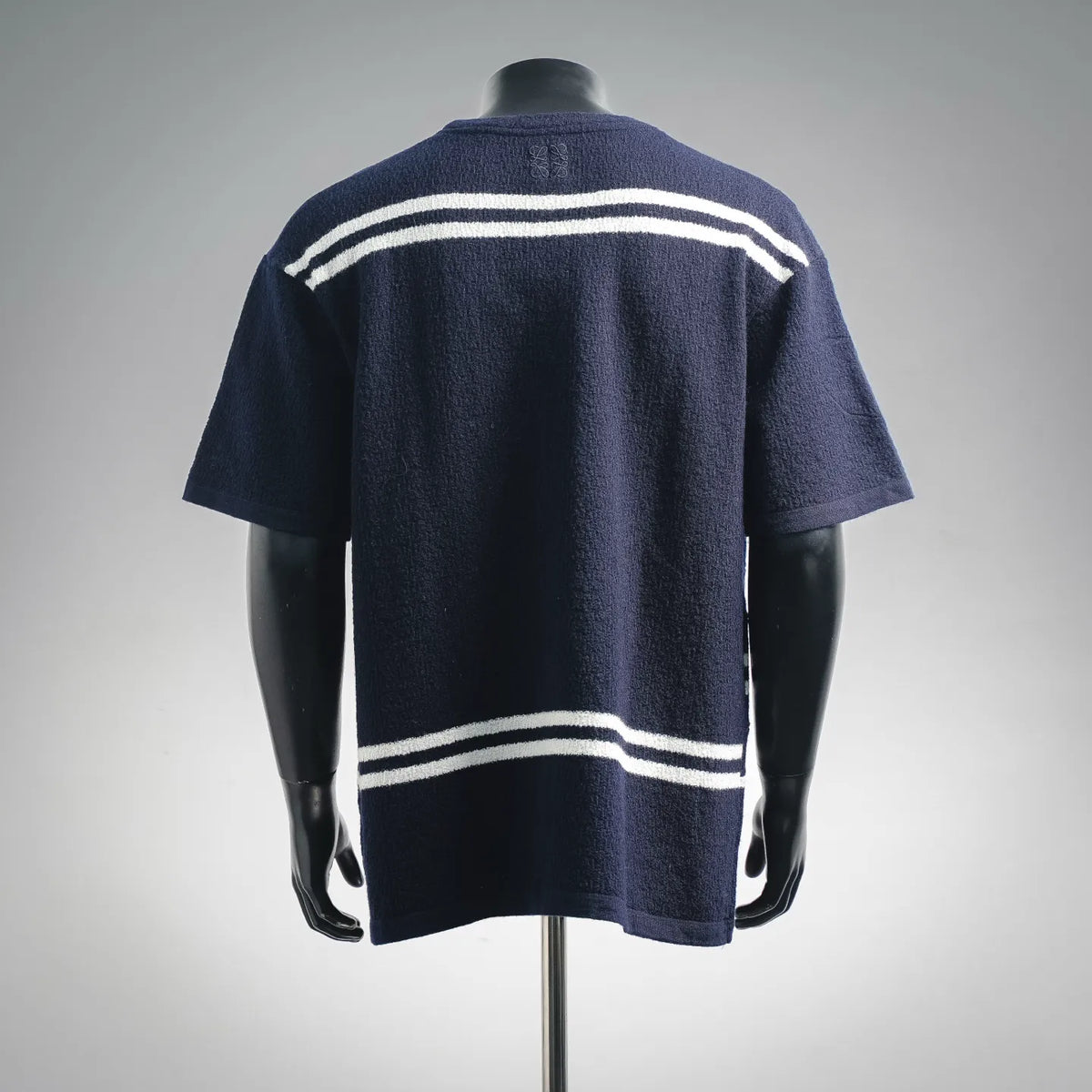 Navy short-sleeve knit sweater with white striped bands on the back