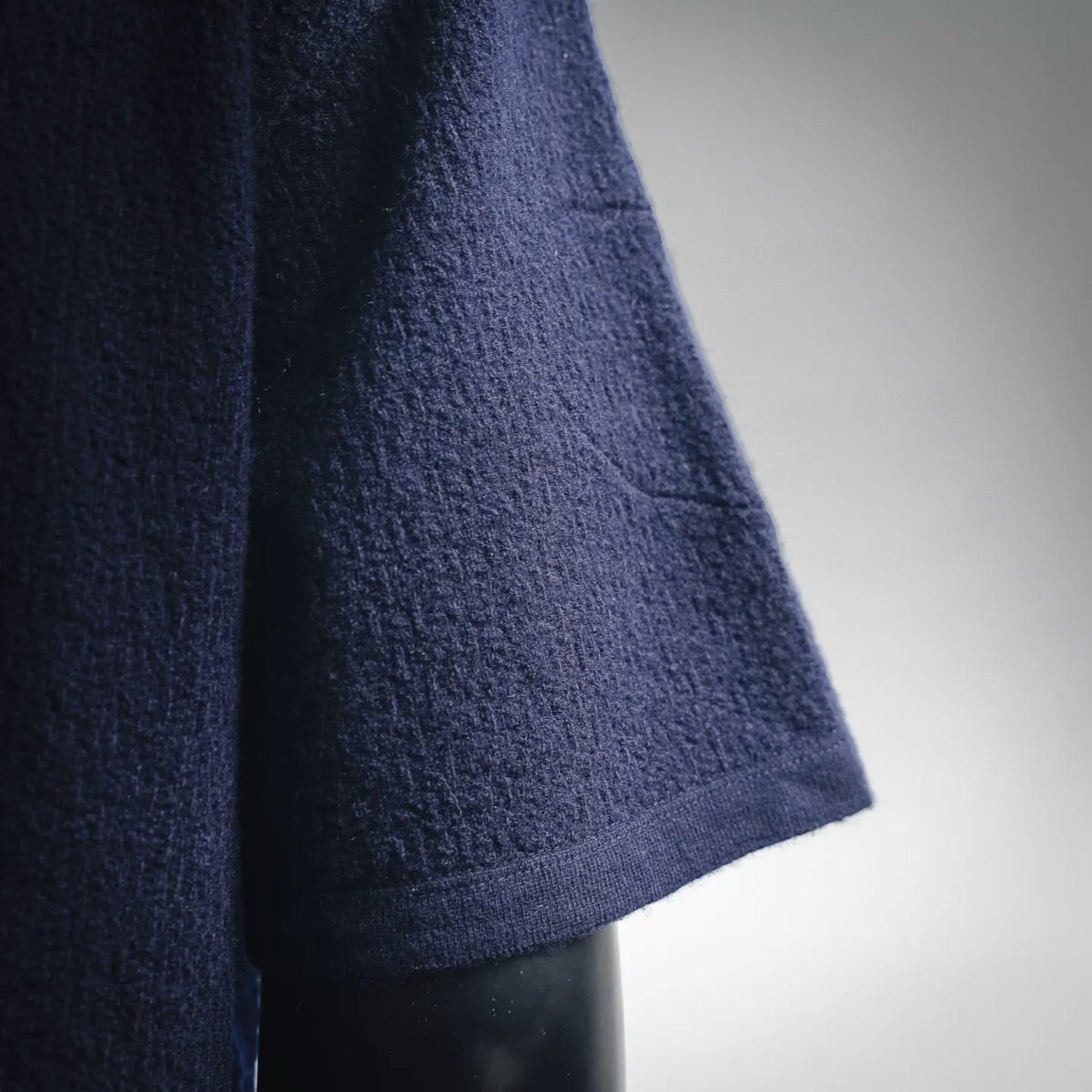 Navy short-sleeve knit sweater sleeve with textured fabric and ribbed cuff