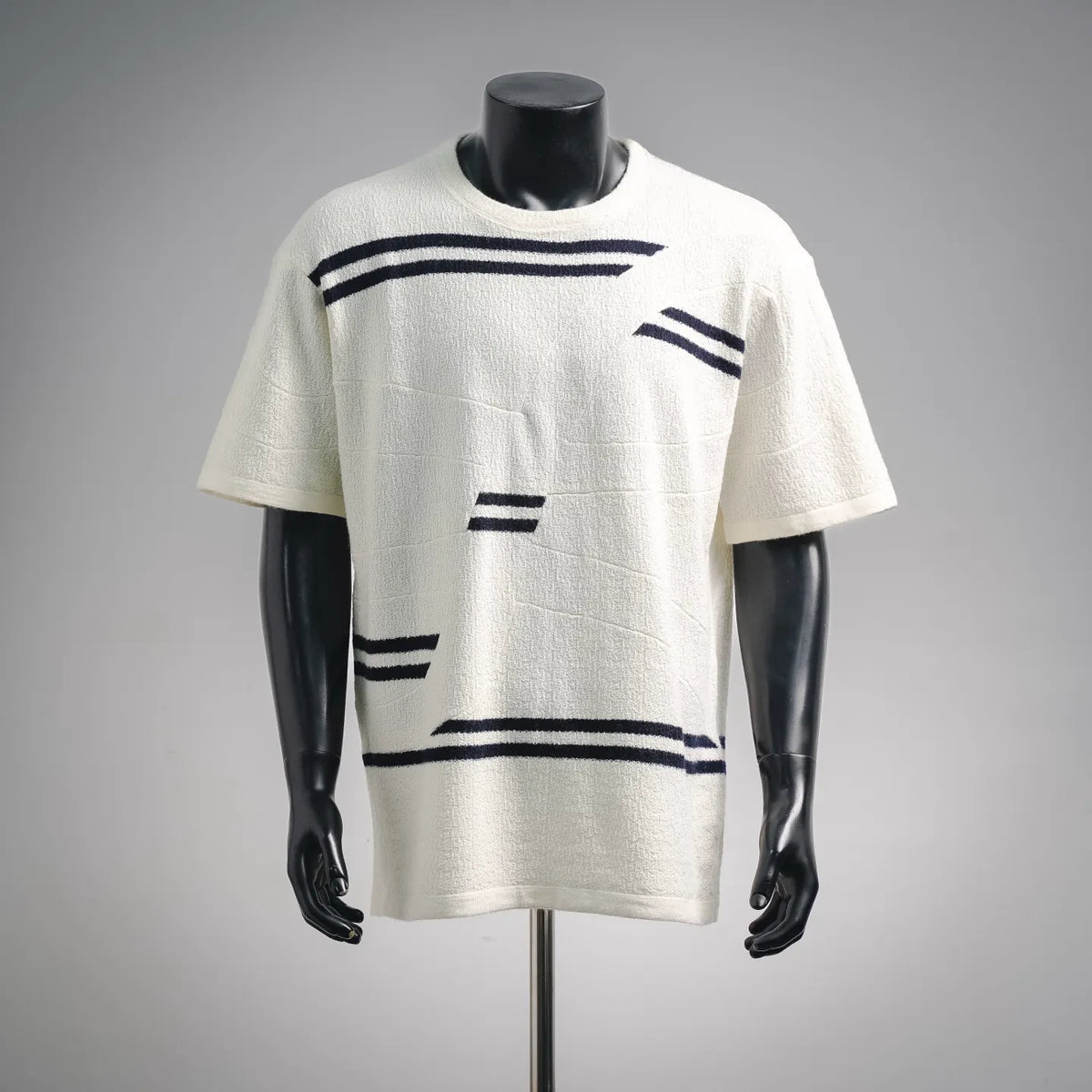 White short-sleeve shirt with navy graphic stripe print on front