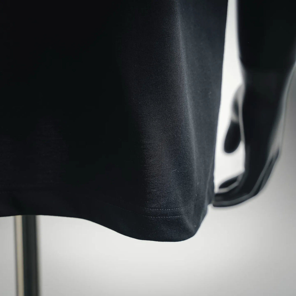 LOEWE dark T-shirt lower side with curved hem and visible stitching