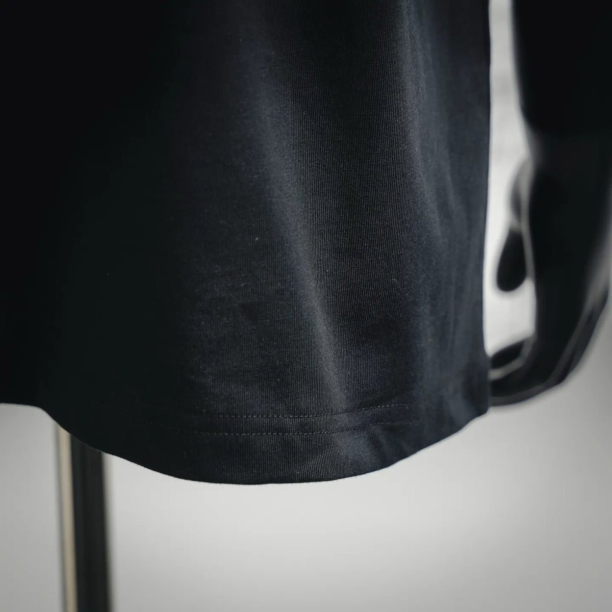 Black T-shirt hem with neat stitched edge