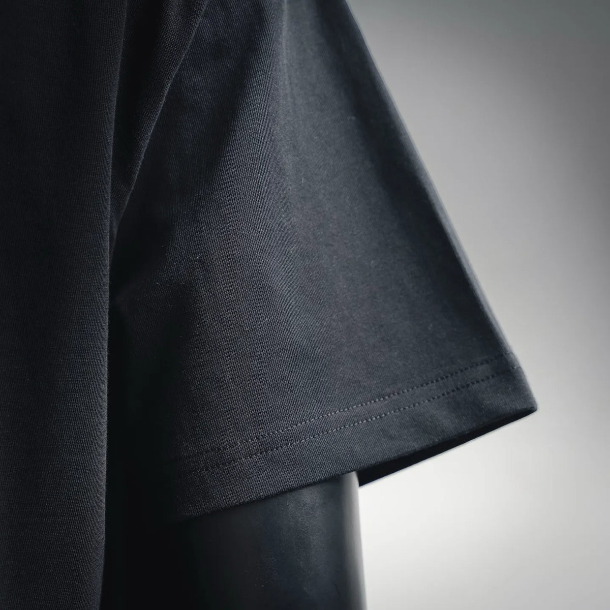 Black T-shirt side hem with smooth stitched seam