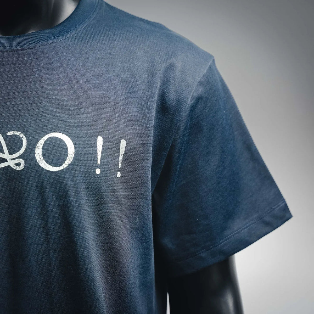 Dark blue short-sleeve shirt back with partial white graphic lettering
