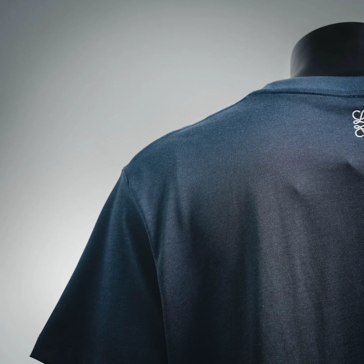 Dark blue short-sleeve shirt back view, plain fabric panel