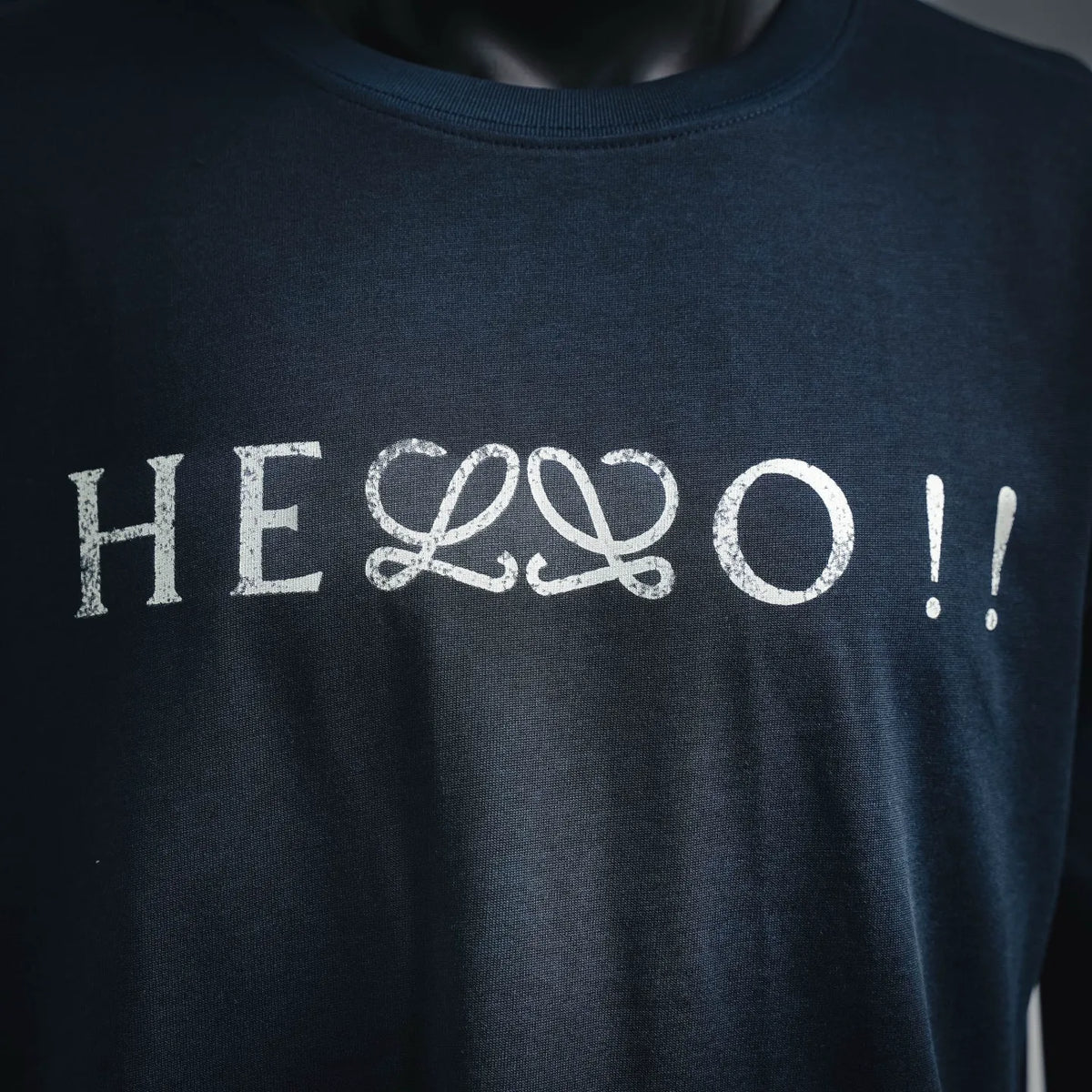 Dark blue short-sleeve crewneck shirt with large white front graphic