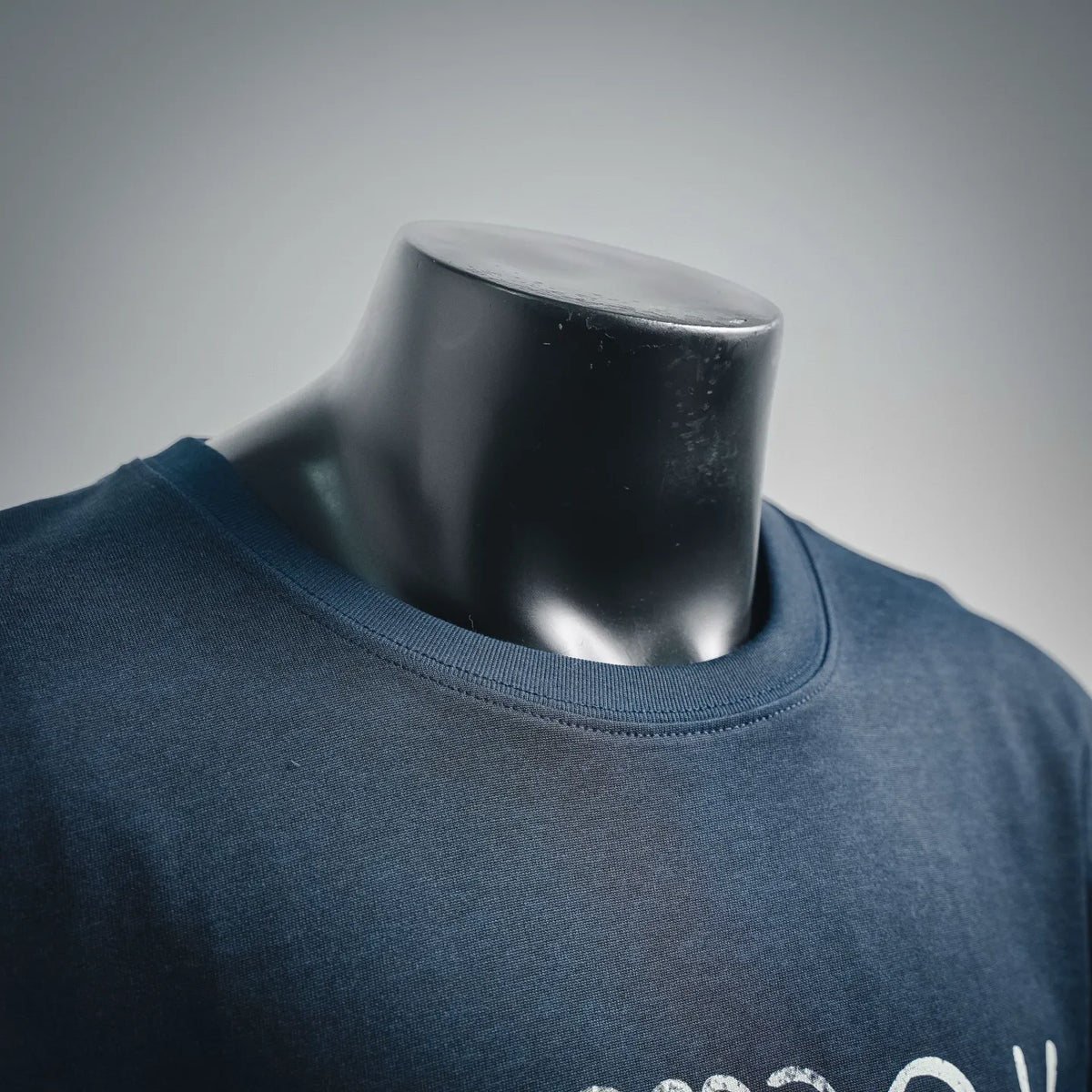 Dark blue short-sleeve crewneck shirt neckline and chest graphic detail