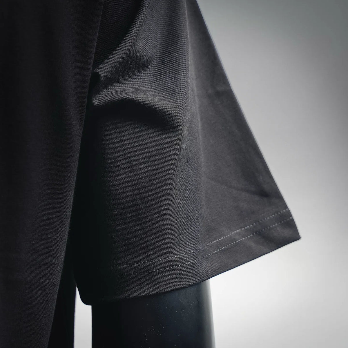 Black T-shirt sleeve hem with visible stitching