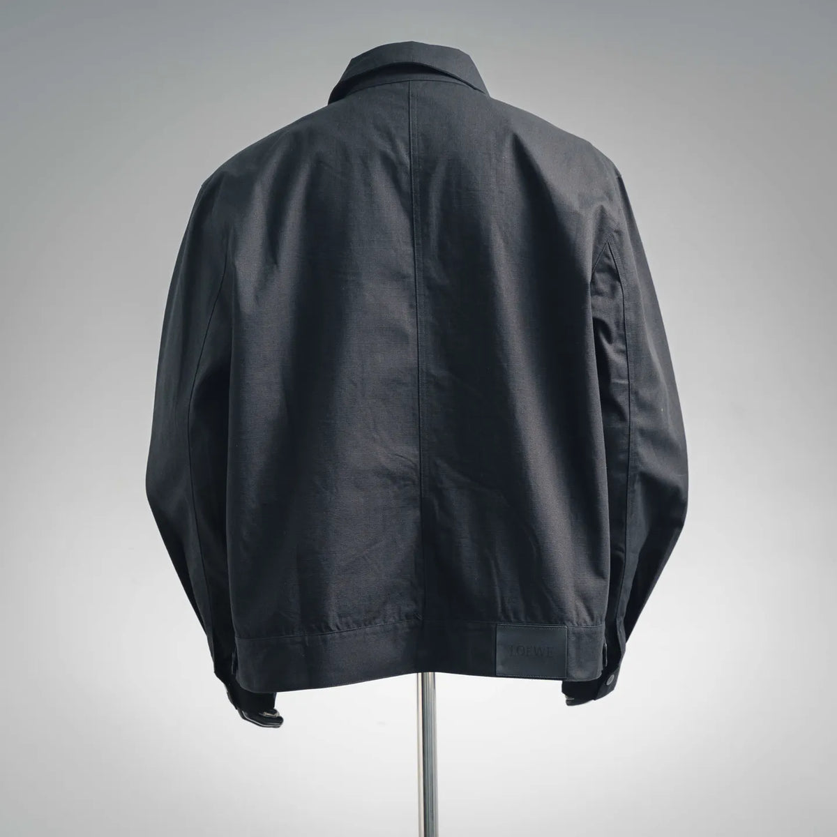 LOEWE coat back view with stand collar, dark fabric