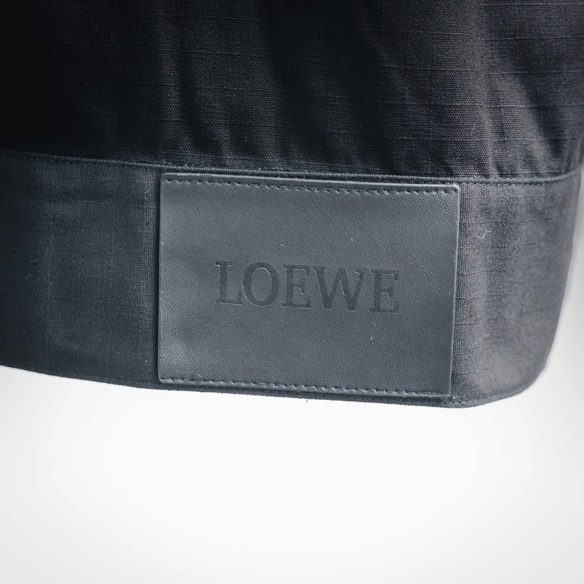 LOEWE coat interior patch label on dark fabric
