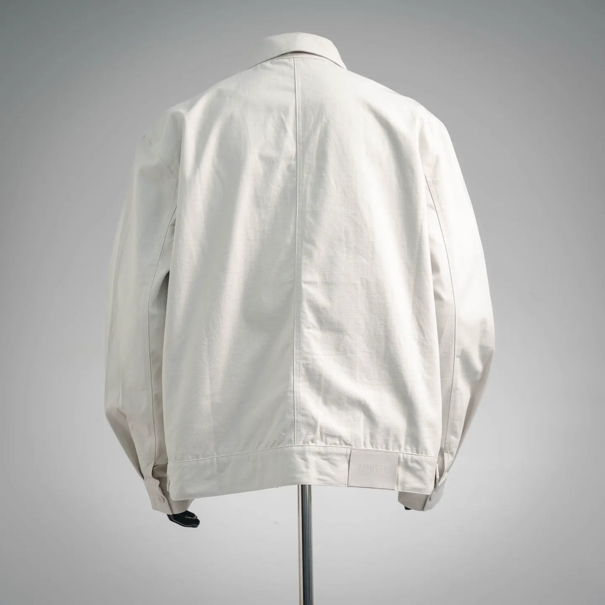 White LOEWE coat back view with vertical seams and full-length zipper