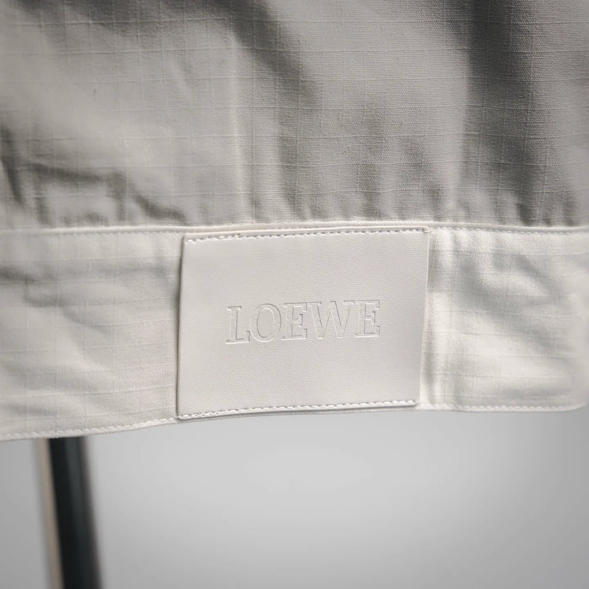 LOEWE logo patch label on white coat waistband