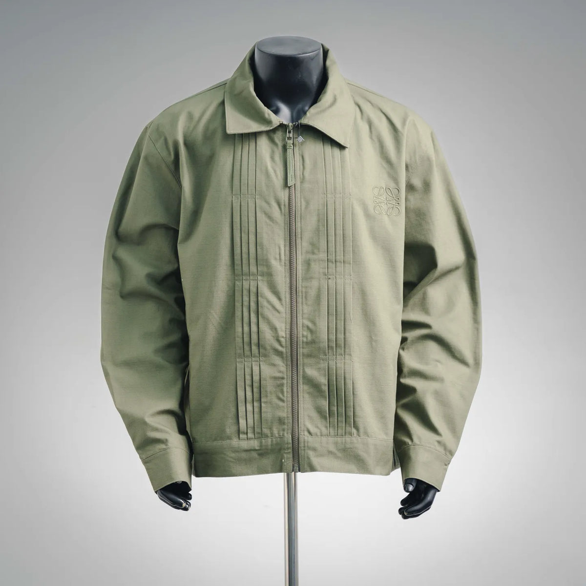 Olive green zip-up coat with stand collar and ribbed front panel detailing