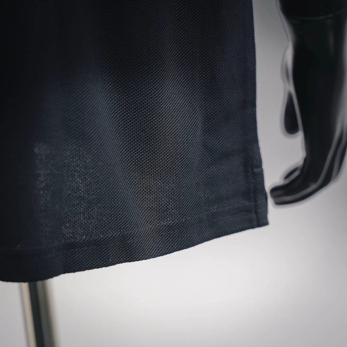 LOEWE polo shirt fabric close-up in dark textured knit